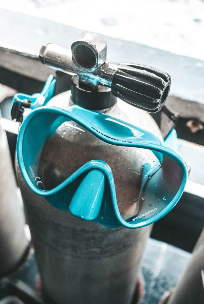Blue scuba mask on a tank
