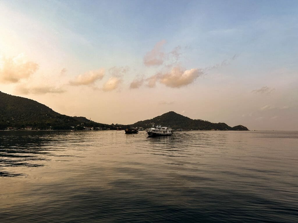 Sunrise over Koh Tao with dive boat in the water