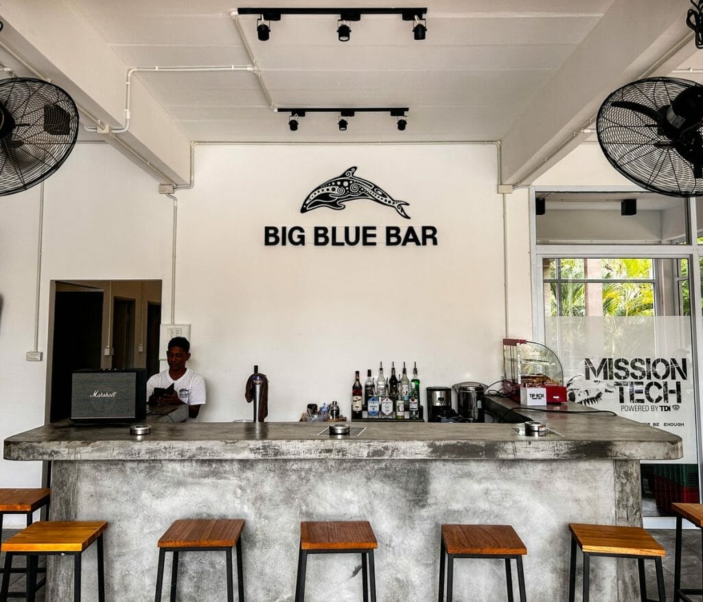 Bar at Big Blue Diving with stools and bartender