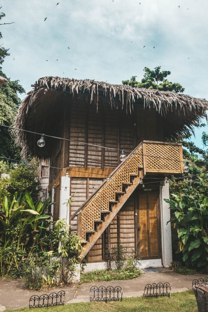 roomes in thatched roof house with stairs at Bongo Divers